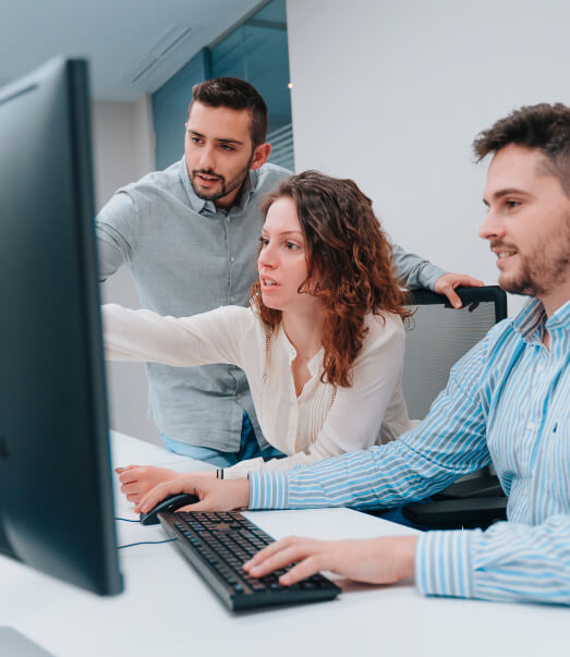 two-guys-woman-coworkers-looking-computer-while-trying-solve-problem